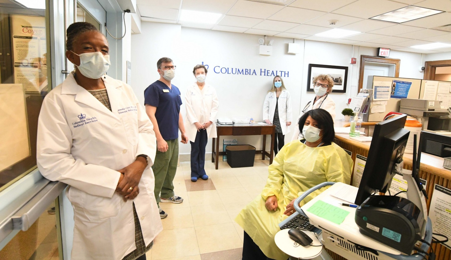 medical services team members standing in lobby with masks on