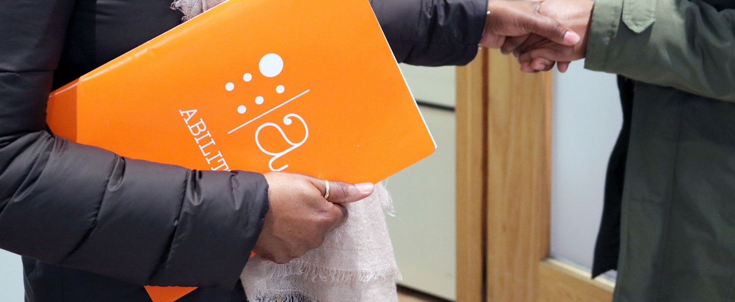 Student holding a Disability Services folder