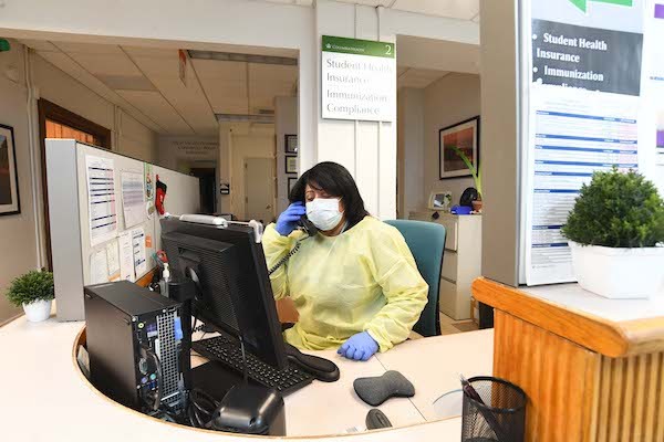 Medical Services employee speaking on the phone answering student questions and making appointments