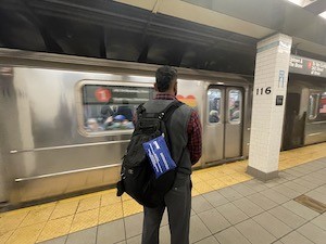 Affiliate with naloxone kit in backpack standing at 116th St. subway station.