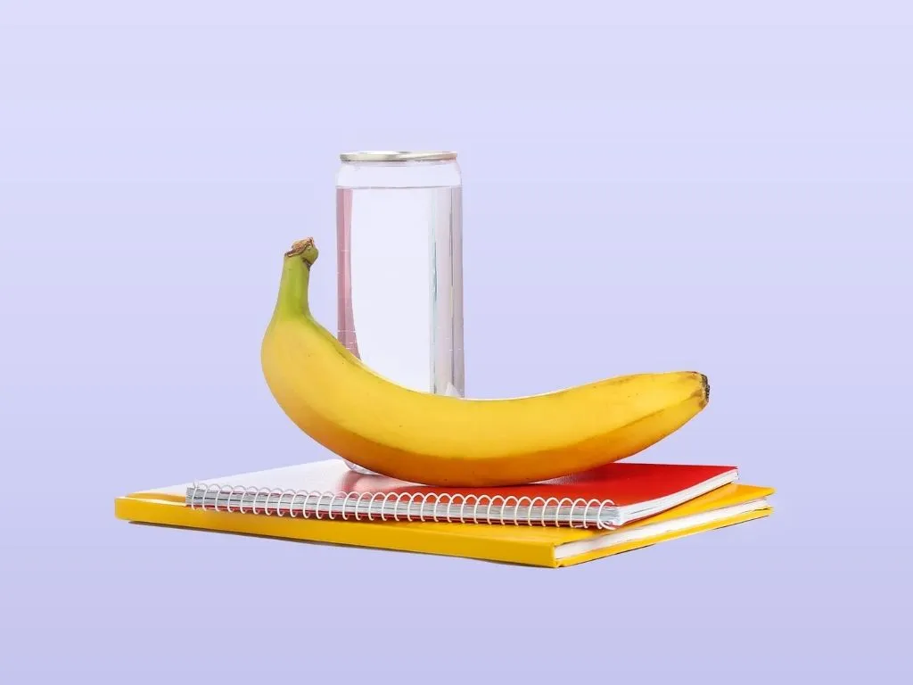 Snack of a banana and a water with notebooks